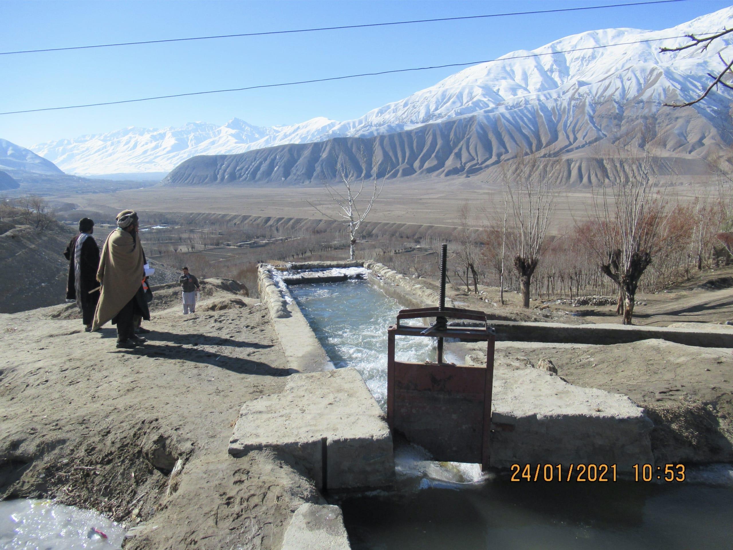 The forebay (to the front) and spillway (to the right side) of a MHP in Baharak district, province of Badakhshan.